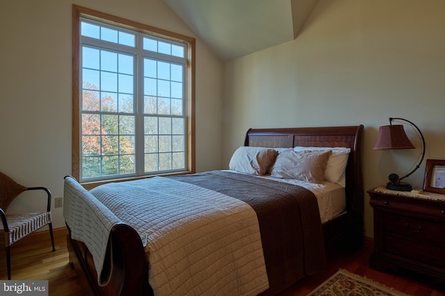 bedroom featuring hardwood / wood-style flooring and lofted ceiling