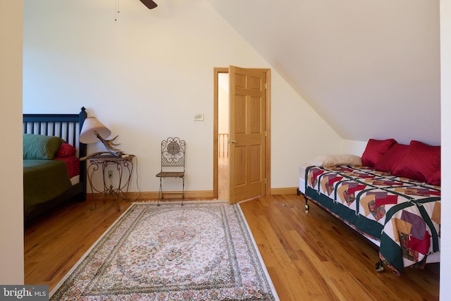 bedroom featuring lofted ceiling, wood-type flooring, and ceiling fan