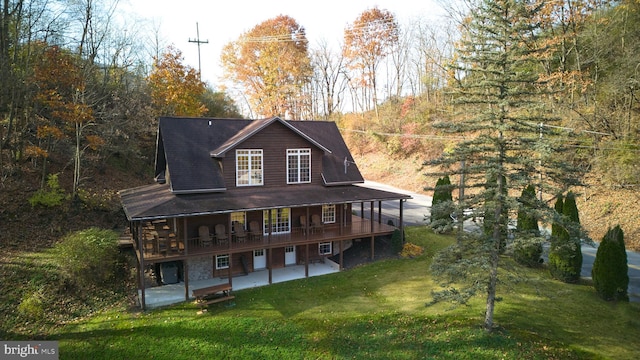 back of property featuring a lawn