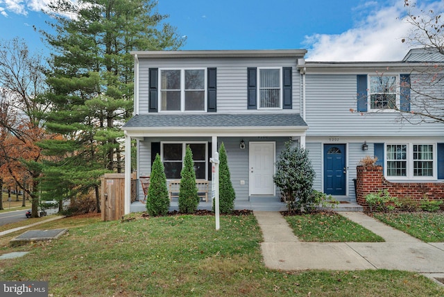 view of property featuring a front lawn