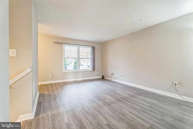 unfurnished room featuring hardwood / wood-style flooring