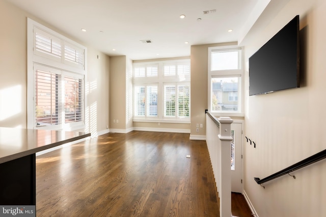 unfurnished living room with dark hardwood / wood-style floors