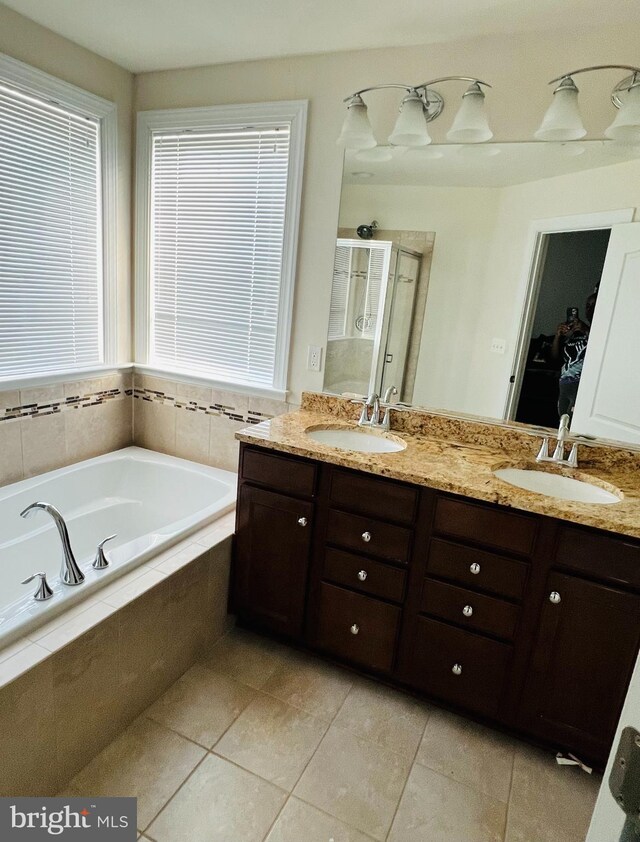 bathroom featuring tile patterned floors, vanity, and separate shower and tub