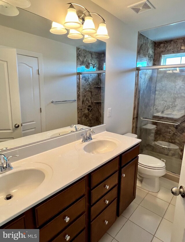 bathroom with tile patterned floors, an enclosed shower, vanity, a notable chandelier, and toilet