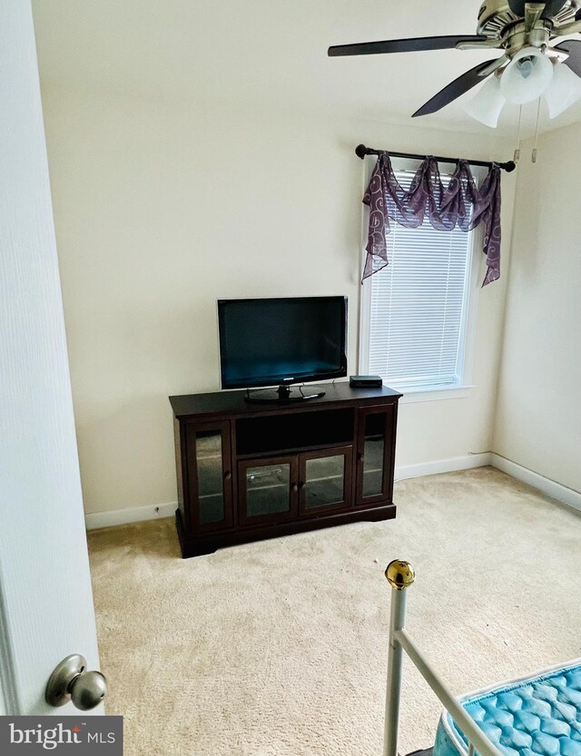 living room featuring light carpet and ceiling fan