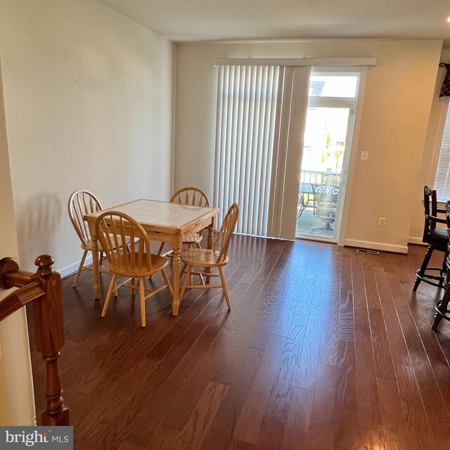 dining space with dark hardwood / wood-style floors