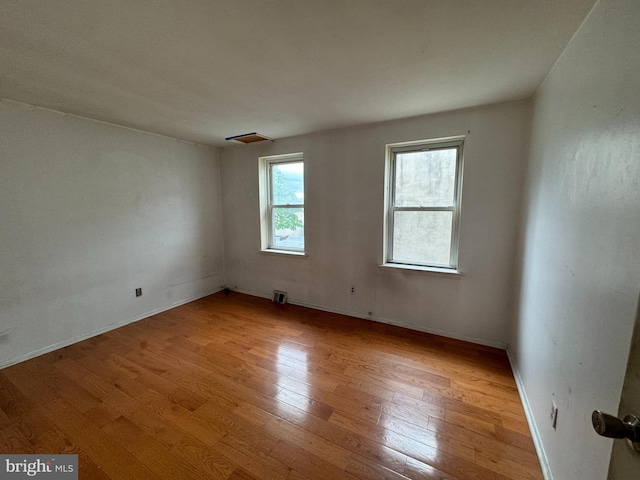 spare room featuring light hardwood / wood-style floors