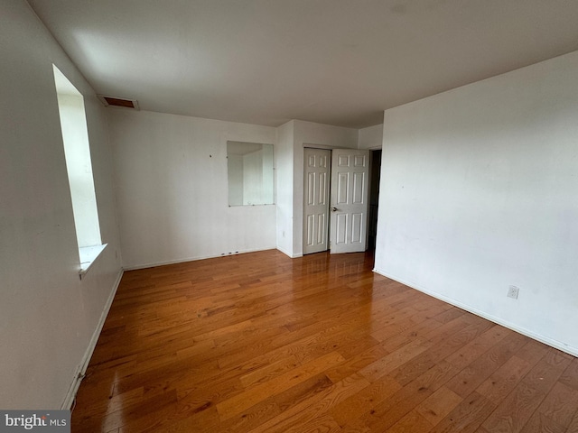 empty room with hardwood / wood-style floors