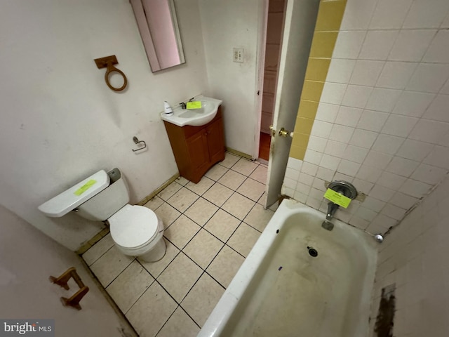 bathroom featuring a bath, toilet, tile patterned flooring, and vanity