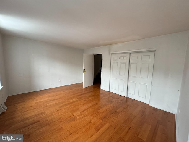 unfurnished bedroom featuring a closet and wood-type flooring