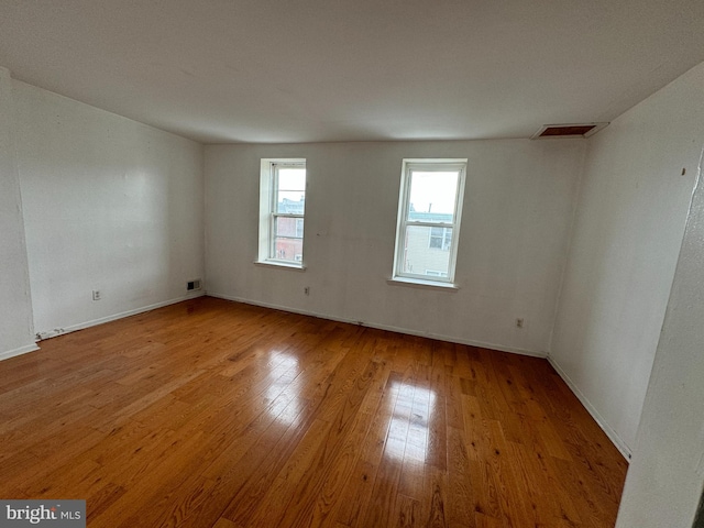 unfurnished room with light hardwood / wood-style floors