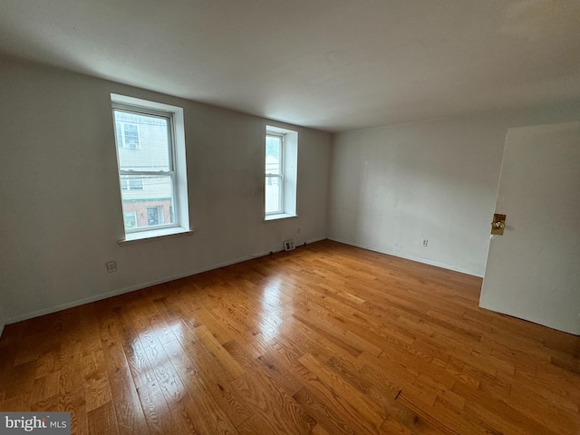 unfurnished room with light hardwood / wood-style flooring