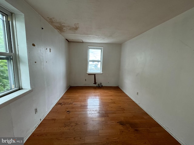 unfurnished room featuring hardwood / wood-style flooring