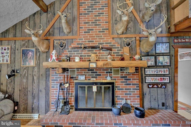 interior details with wood walls, beam ceiling, and a brick fireplace