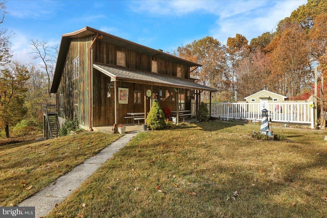 exterior space featuring a lawn and a porch