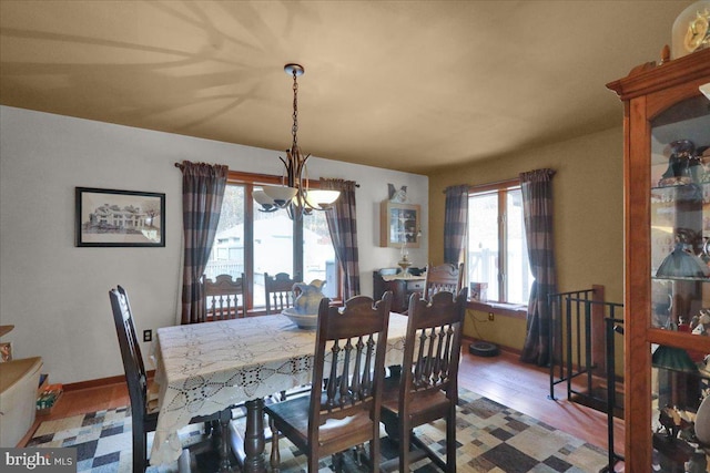 dining area featuring a notable chandelier and wood-type flooring