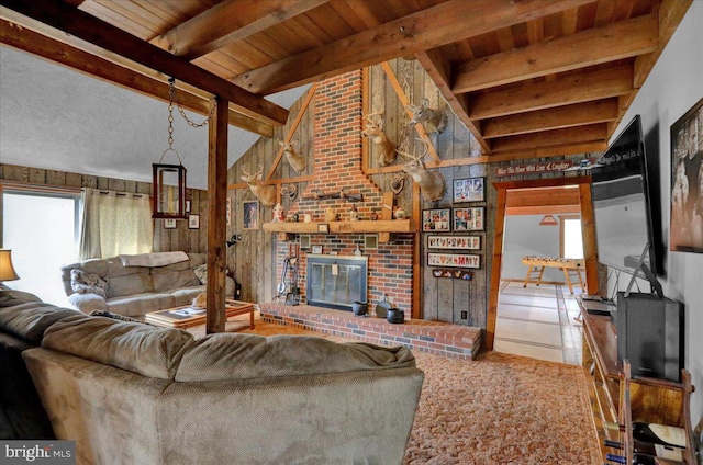 living room with tile patterned floors, lofted ceiling with beams, a brick fireplace, and wood ceiling