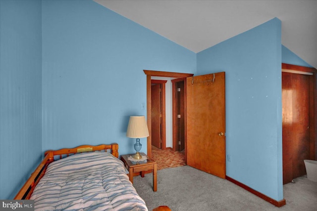 bedroom featuring light carpet and lofted ceiling