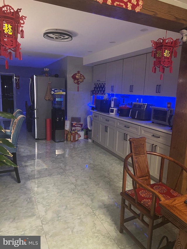 kitchen featuring decorative backsplash and stainless steel fridge