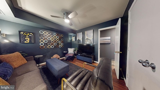 living room with hardwood / wood-style flooring and ceiling fan