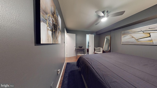 bedroom featuring hardwood / wood-style floors, ceiling fan, and a closet