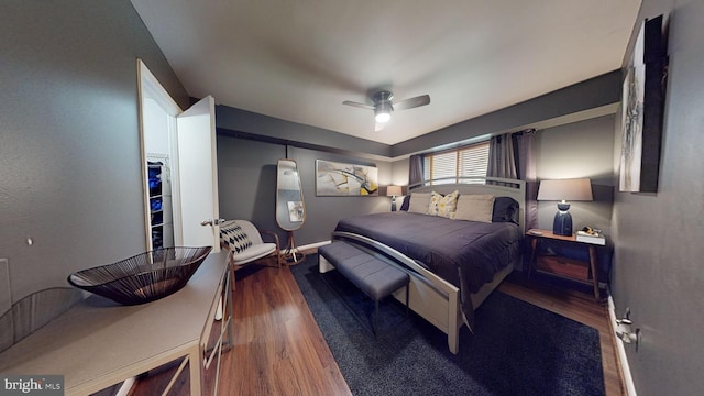 bedroom with dark wood-type flooring and ceiling fan