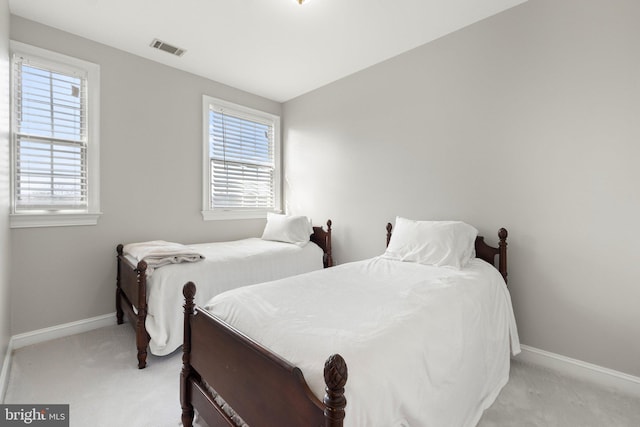 carpeted bedroom featuring lofted ceiling and multiple windows