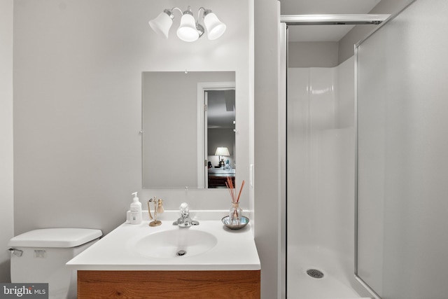 bathroom featuring vanity, toilet, and a shower with door