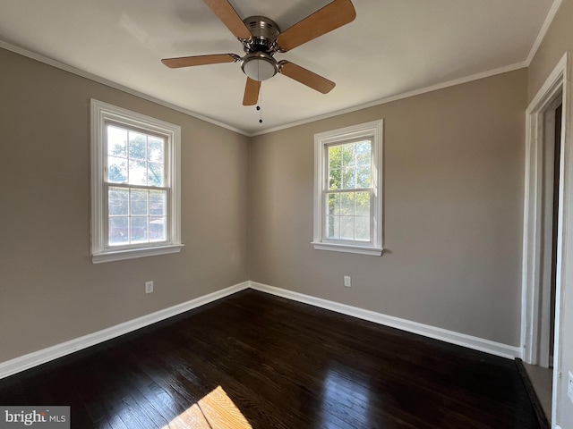 empty room with ornamental molding, dark hardwood / wood-style floors, and ceiling fan