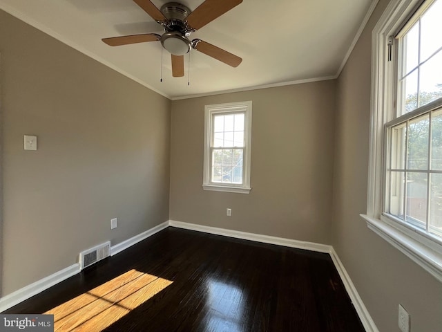 spare room featuring ornamental molding, dark wood-type flooring, and ceiling fan