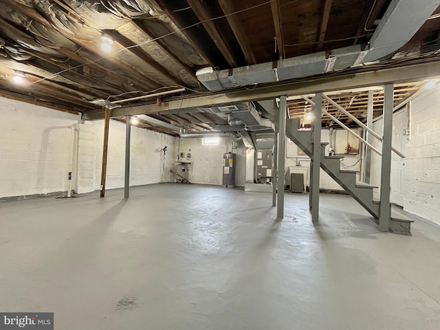 basement featuring heating unit and water heater