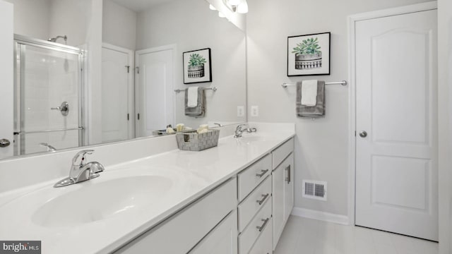 bathroom featuring vanity and a shower with shower door