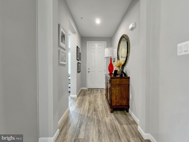 corridor with light wood-type flooring