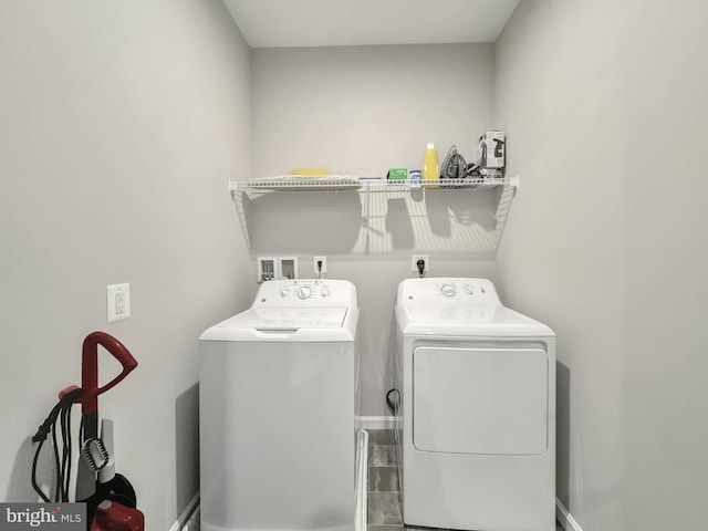 clothes washing area with washing machine and clothes dryer