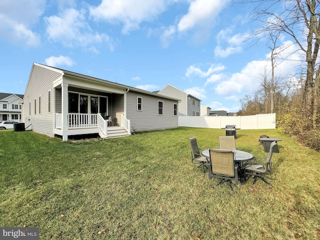 rear view of property featuring a lawn