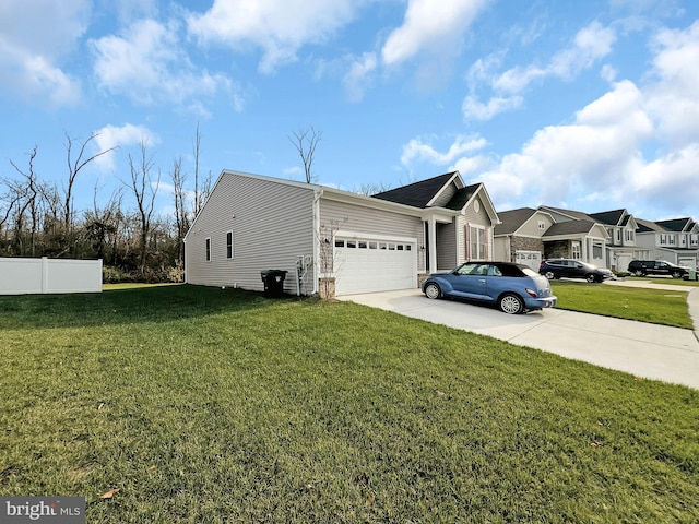 view of front of property with a front yard and a garage