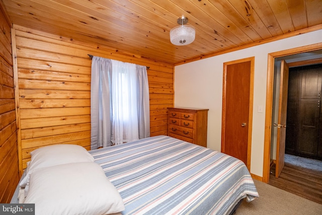 carpeted bedroom featuring wood walls, wood ceiling, and ornamental molding