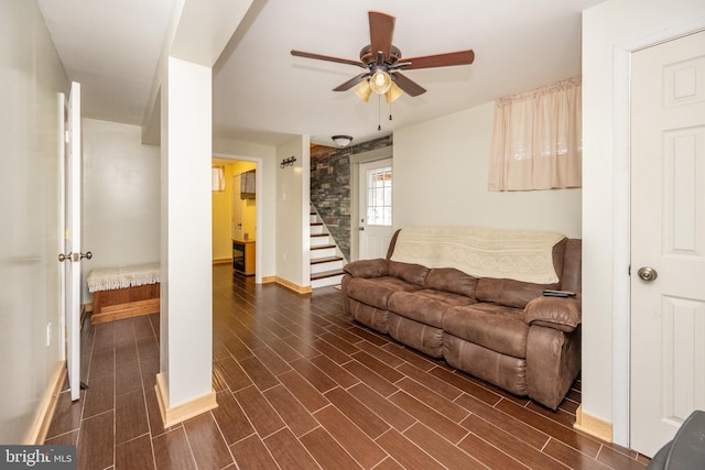 living room with dark hardwood / wood-style flooring and ceiling fan