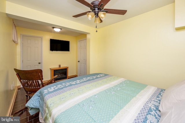 bedroom with ceiling fan and dark hardwood / wood-style floors