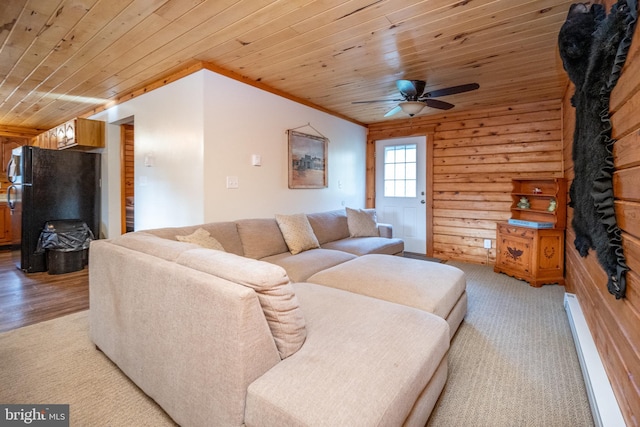 living room with light hardwood / wood-style flooring, wood walls, wooden ceiling, and a baseboard radiator