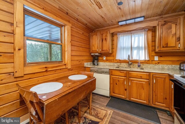 kitchen featuring sink, black electric range, dark wood-type flooring, wooden walls, and dishwasher