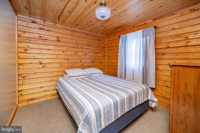 carpeted bedroom featuring wooden walls and wooden ceiling