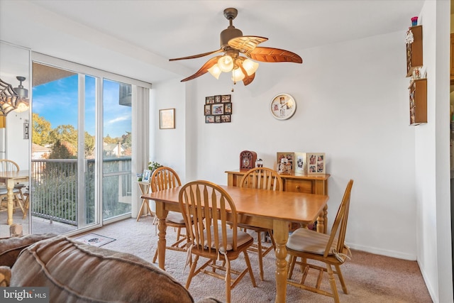 carpeted dining area featuring ceiling fan