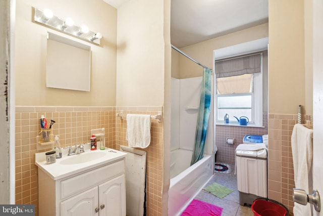 bathroom featuring tile walls, shower / bath combo, vanity, and tile patterned floors