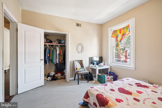 carpeted bedroom with a closet