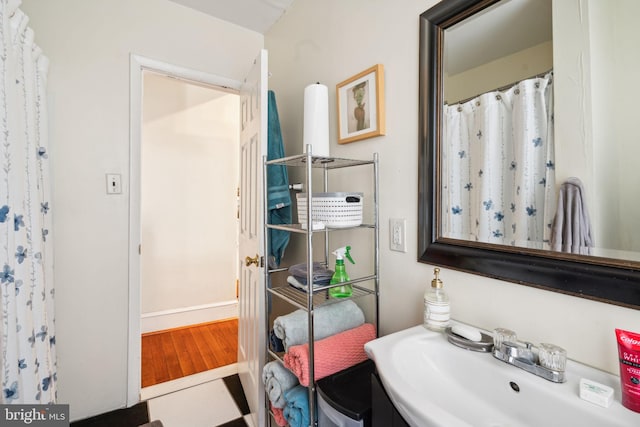 bathroom with sink and wood-type flooring