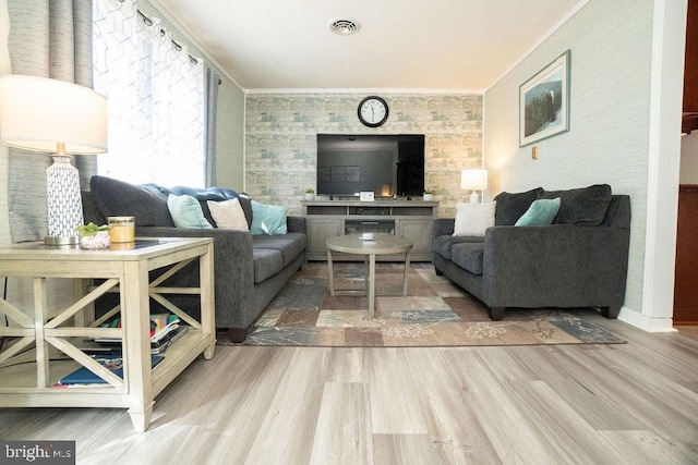 living room with ornamental molding and hardwood / wood-style floors