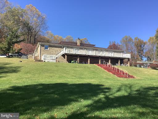 back of house with a yard and a deck