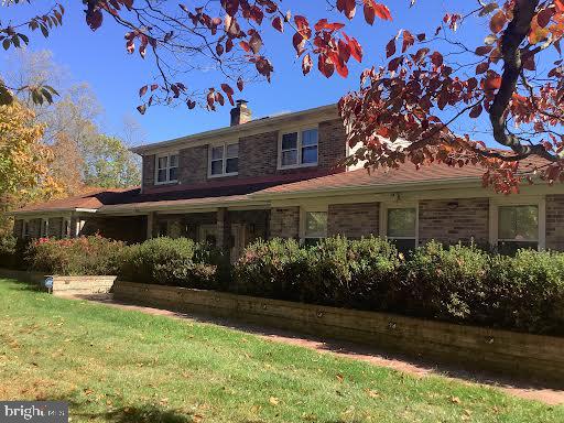 back of property featuring a lawn