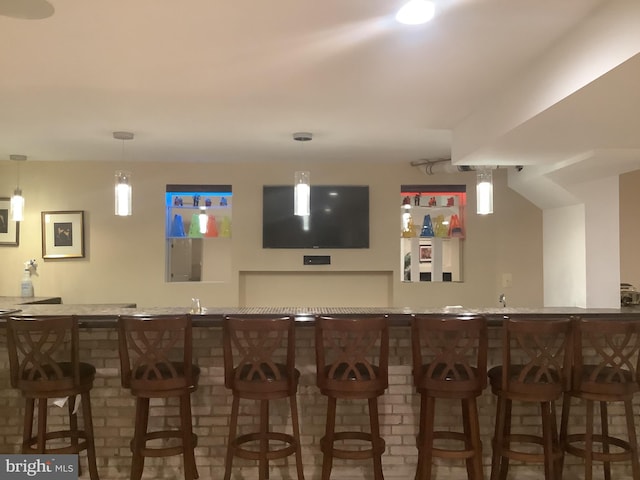 bar featuring decorative light fixtures